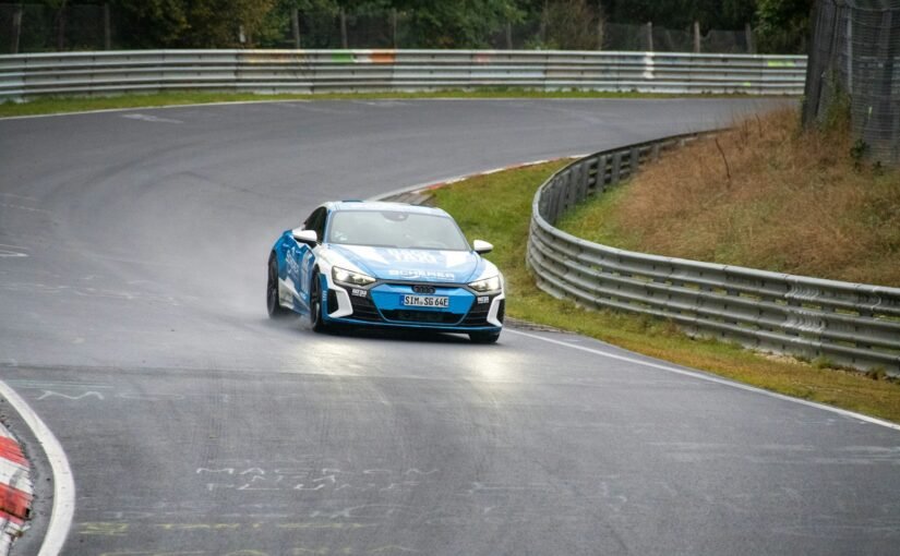 a blue car driving down a race track